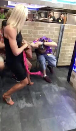 PIC FROM MERCURY PRESS (PICTURED: THE WOMAN THEN ATTACKS LEWIS CALEY IN A TAKE AWAY IN CLACTON-ON-SEA IN ESSEX) This is the moment a foul-mouthed blonde lady launched herself at a drunken reveller in a shocking takeaway brawl - because he suggested she was in her 60s and threw a chip in her face. Lewis Caley and his friends were getting food from the Quality Diner takeaway in Clacton-on-Sea, Essex, after celebrating his 20th birthday. However an argument ensued when cocky Lewis asked one of the women - estimated to be in her 30s - how old she was and then jokingly suggested she was in her 60s. Footage shows the blonde brand jolly engineer Lewis a c**t and then repeatedly try to snatch his food from him as he sits eating. SEE MERCURY COPY