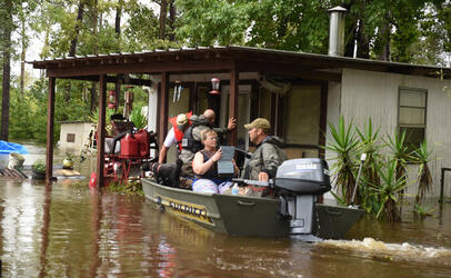 August 31, 2017 - Calcasieu Parish, Louisiana, United States: Calcasieu Parish Sheriff's Deputies, Marine Division, Sgt. Kevin Fruge, right and Sgt. Kyle Miers, left, rescue Randall Trahan from his flooded home on the Calcasieu River Wednesday. Already in the boat is Deanna Turner, seated center, also rescued from her home next door as rain from Hurricane Harvey caused flooding on almost all tributaries and rivers in the Parish. (Patrick Dennis/The Advocate / Polaris)