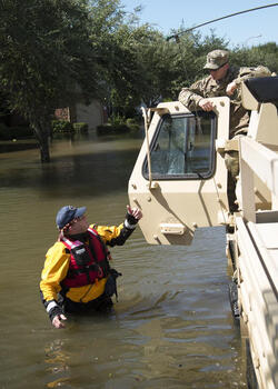 August 30, 2017 - Sugarland, Texas, United States: Army National Guard Sgt. 1st Class Jacob Padgett and Rescue Specialist Samuel Hendricks, Texas Task Force 1, coordinate the evacuation of residents in flood effected area, due to devastating effects caused by Hurricane Harvey's aftermath. Harvey made landfall into the Texas coast last week as a category 4 hurricane. (Polaris)