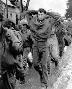 THE STORY of an unsung unit of Second Word War soldiers who stood alongside the infamous ‘Band of Brothers’ as they often fought to the last man to repel Hitler’s last big offensive has been released in a new book detailing their previously little reported struggle. Images show how this unknown band of brothers dug into fox holes in the middle of the snowy Ardennes forest as they wait for the German army to advance, while others see troops stood over the bodies of their fallen comrades. In another picture, a soldier can be seen aiming his rifle at a group of German prisoners, moving them on as they walk with their hands over their heads. The images are from the new book The 110th Holds in the Ardennes by Walter S. Zapotoczny Jr, which tells the tale of how the 110th infantry 28th division held a line through the formidable Ardennes forest against the might of Hitler’s army / Fonthill Media / mediadrumworld.com