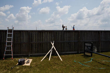 September 2, 2017 - Fort Bend County, Texas, United States: Local residents walk along the levee along a canal near the Brazos river to get to their homes in the Millwood subdivision of Fort Bend County. (Marcus Yam / Los Angeles Times/Polaris)