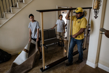 September 2, 2017 - Fort Bend County, Texas, United States: Local residents clear out damaged hardwood floors and carpet in homes damaged in the aftermath of tropical storm Harvey, in the Millwood subdivision of Fort Bend County. (Marcus Yam / Los Angeles Times/Polaris)