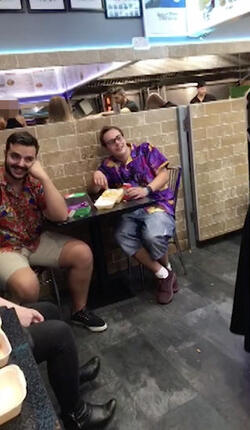 PIC FROM MERCURY PRESS (PICTURED: LEWIS CALEY ATTEMPTING TO SHARE A JOKE WITH THE BLONDE WOMAN IN A TAKE AWAY IN CLACTON-ON-SEA IN ESSEX) This is the moment a foul-mouthed blonde lady launched herself at a drunken reveller in a shocking takeaway brawl - because he suggested she was in her 60s and threw a chip in her face. Lewis Caley and his friends were getting food from the Quality Diner takeaway in Clacton-on-Sea, Essex, after celebrating his 20th birthday. However an argument ensued when cocky Lewis asked one of the women - estimated to be in her 30s - how old she was and then jokingly suggested she was in her 60s. Footage shows the blonde brand jolly engineer Lewis a c**t and then repeatedly try to snatch his food from him as he sits eating. SEE MERCURY COPY