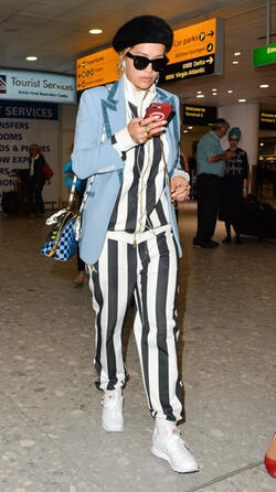 Rita Ora in a Striped Track Suit at Heathrow Airport