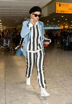 Rita Ora in a Striped Track Suit at Heathrow Airport
