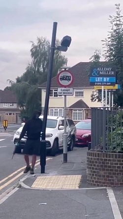 VIDEO Disgruntled masked man hacks down London ULEZ camera in broad daylight 48 hours after it was installed