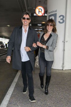 Milla Jovovich and husband director Paul W. S. Anderson were spotted returning to Los Angeles at LAX.