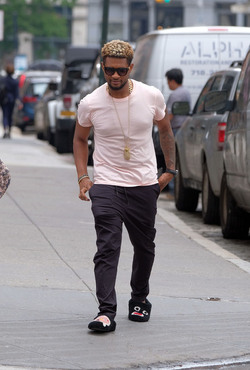 Usher wears comical slippers as he walks in Tribeca