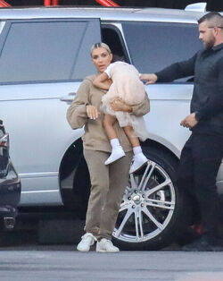 Kim Kardashian carrying a sleepy princess Nori