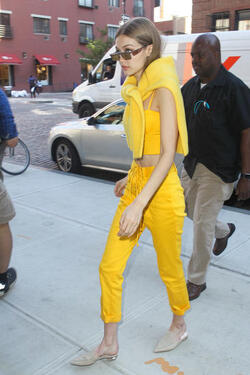 Gigi Hadid wears an all yellow ensemble as she arrives at her apartment