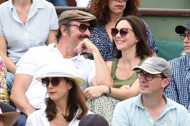 Jean Dujardin and his wife Nathalie Pechalat keep each other moisturised at the French Tennis Open at Roland Garros
