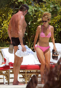 Baywatch actor David Hasselhoff wears tiny black swim trunks as he relaxes with his bikini clad finance Hayley Roberts by the pool in Miami.