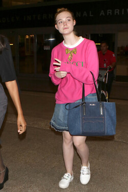 Elle Fanning so pretty in pink Gucci shirt at LAX