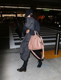 Vanessa Hudgens isn t feeling camera ready and hides her face with a scarf after landing at LAX. Vanessa Hudgens isn t feeling camera ready and hides her face with a scarf after landing at LAX.