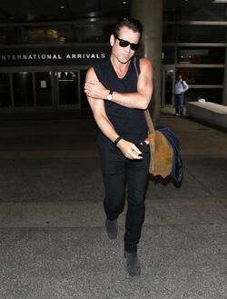 Colin Farrell was spotted in a sleeveless t shirt at LAX