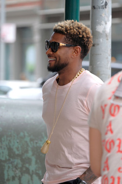 Usher wears comical slippers as he walks in Tribeca