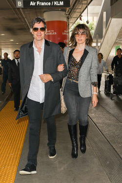 Milla Jovovich and husband director Paul W. S. Anderson were spotted returning to Los Angeles at LAX.