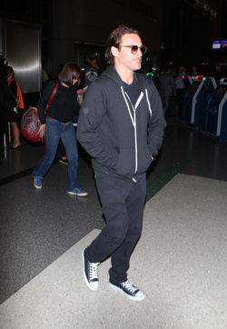 The enigmatic Joaquin Phoenix sports a scruffy beard zip up hoodie and shades as he spends National Brother s Day catching a flight with his lovely sister Summer.