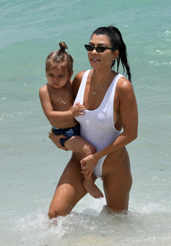 Kourtney Kardashian spends a day at the beach with her kids.. in a very sexy white swimsuit Kourtney Kardashian spends a day at the beach with her kids.. in a very sexy white swimsuit