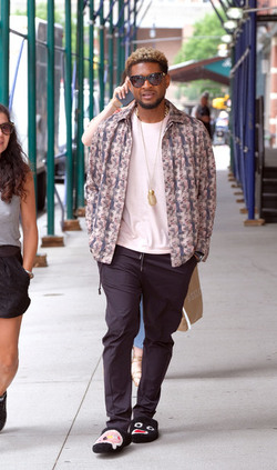 Usher wears comical slippers as he walks in Tribeca