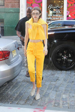 Gigi Hadid wears an all yellow ensemble as she arrives at her apartment