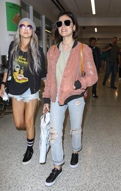 Pretty Little Liars star Lucy Hale looks cute in a rose colored silk bomber light green tee ripped jeans and black tennis shoes as she touches down in L.A. after a long flight from NYC. Pretty Little Liars star Lucy Hale looks cute in a rose colored silk bomber light green tee ripped jeans and black tennis shoes as she touches down in L.A. after a long flight from NYC.