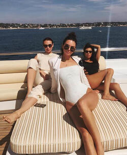 He certainly has some thong to smile about Side boob flashing Kourtney Kardashian s toyboy lover grins as she flaunts her behind in TINY bikini for another day frolicking on a yacht in Cannes