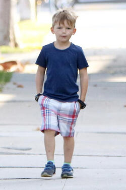 Jennifer Garner carries a school project as she takes her kids to school