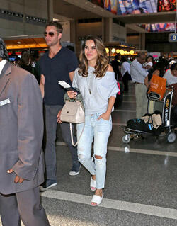 Justin Hartley And Fiance Chrishell Stause Head Out Of LAX On Romantic Holiday