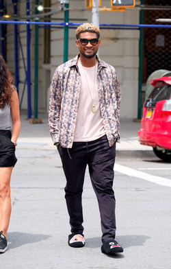 Usher wears comical slippers as he walks in Tribeca