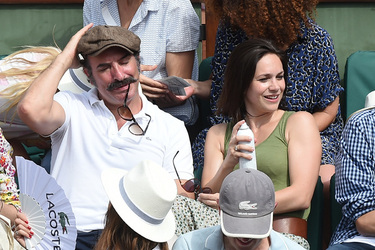 Jean Dujardin and his wife Nathalie Pechalat keep each other moisturised at the French Tennis Open at Roland Garros