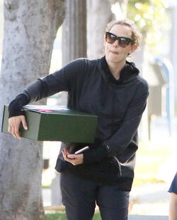 Jennifer Garner carries a school project as she takes her kids to school