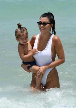 Kourtney Kardashian spends a day at the beach with her kids.. in a very sexy white swimsuit Kourtney Kardashian spends a day at the beach with her kids.. in a very sexy white swimsuit