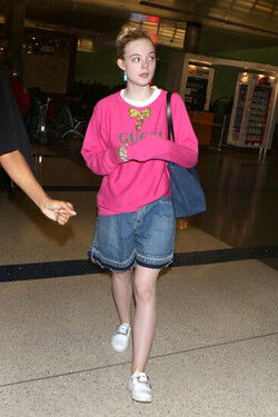 Elle Fanning so pretty in pink Gucci shirt at LAX