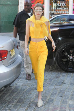 Gigi Hadid wears an all yellow ensemble as she arrives at her apartment