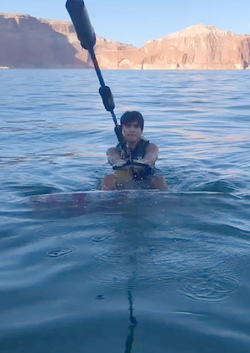 HIGH SCHOOL GRADUATE TAKES UNIQUE GRADUATION PHOTOS WHILE WAKESURFING