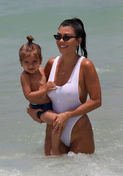 Kourtney Kardashian spends a day at the beach with her kids.. in a very sexy white swimsuit Kourtney Kardashian spends a day at the beach with her kids.. in a very sexy white swimsuit
