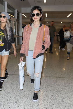 Pretty Little Liars star Lucy Hale looks cute in a rose colored silk bomber light green tee ripped jeans and black tennis shoes as she touches down in L.A. after a long flight from NYC. Pretty Little Liars star Lucy Hale looks cute in a rose colored silk bomber light green tee ripped jeans and black tennis shoes as she touches down in L.A. after a long flight from NYC.