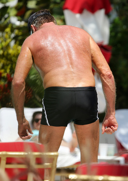 Baywatch actor David Hasselhoff wears tiny black swim trunks as he relaxes with his bikini clad finance Hayley Roberts by the pool in Miami.