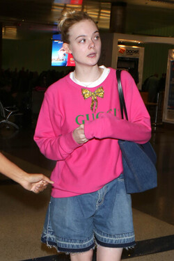 Elle Fanning so pretty in pink Gucci shirt at LAX