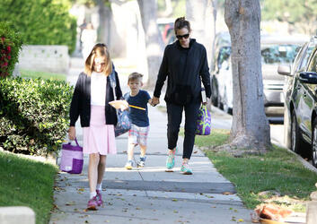 Jennifer Garner carries a school project as she takes her kids to school