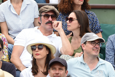 Jean Dujardin and his wife Nathalie Pechalat keep each other moisturised at the French Tennis Open at Roland Garros