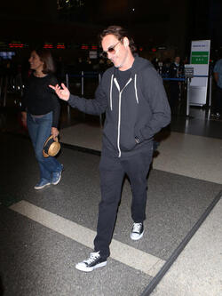 The enigmatic Joaquin Phoenix sports a scruffy beard zip up hoodie and shades as he spends National Brother s Day catching a flight with his lovely sister Summer.
