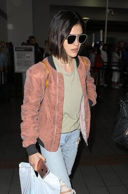 Pretty Little Liars star Lucy Hale looks cute in a rose colored silk bomber light green tee ripped jeans and black tennis shoes as she touches down in L.A. after a long flight from NYC. Pretty Little Liars star Lucy Hale looks cute in a rose colored silk bomber light green tee ripped jeans and black tennis shoes as she touches down in L.A. after a long flight from NYC.