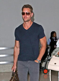 Justin Hartley And Fiance Chrishell Stause Head Out Of LAX On Romantic Holiday
