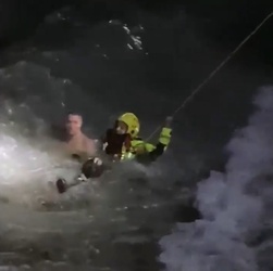 VIDEO Foolish man who went for night time swim in treacherous sea is saved by hero firefighters who dived in after him