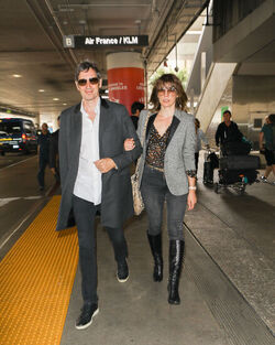 Milla Jovovich and husband director Paul W. S. Anderson were spotted returning to Los Angeles at LAX.
