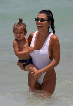 Kourtney Kardashian spends a day at the beach with her kids.. in a very sexy white swimsuit Kourtney Kardashian spends a day at the beach with her kids.. in a very sexy white swimsuit