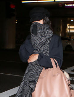 Vanessa Hudgens isn t feeling camera ready and hides her face with a scarf after landing at LAX. Vanessa Hudgens isn t feeling camera ready and hides her face with a scarf after landing at LAX.