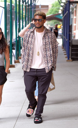 Usher wears comical slippers as he walks in Tribeca